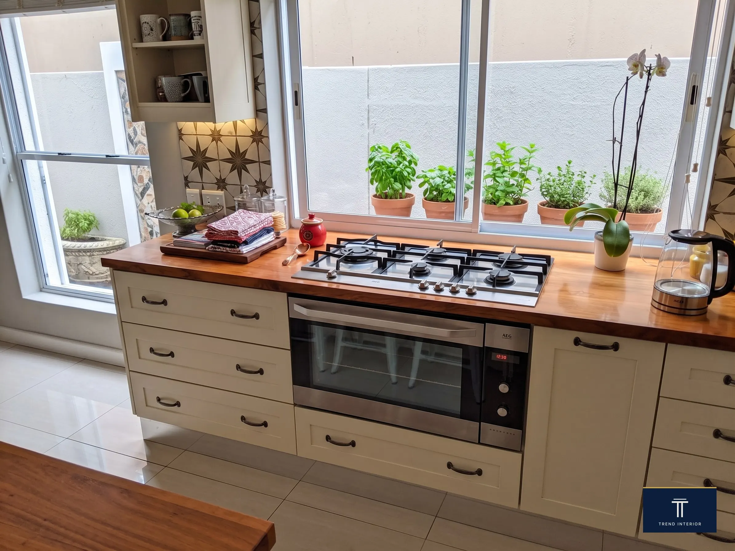Open kitchen with herb garden window, gas hob and oven