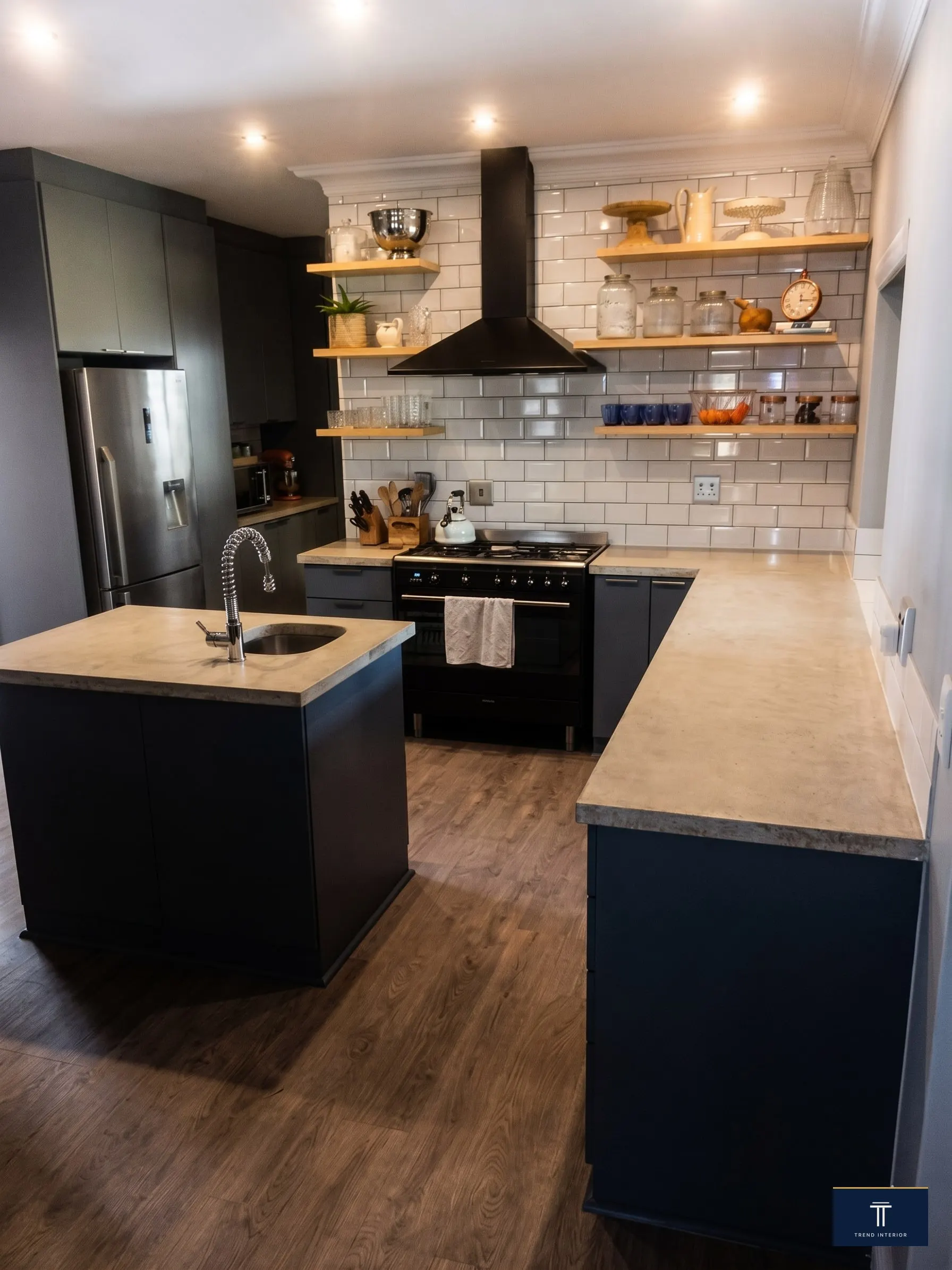 Kitchen with central island, dark stove and warm wood counter
